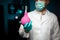 Doctor hand in gloves with medical pink enema syringe isolated on lab background