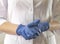 Doctor hands in blue gloves closeup. Nurse in uniform arms close up