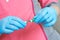 Doctor hands in blue gloves hold syringe. Preparation for blood test. Medical woman holding injector in arm.