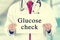 Doctor hands holding white card sign with glucose check text message