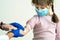 Doctor hands making disinfection preparing hand of child girl for injection wearing blue protective medical mask ill with
