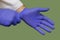 Doctor Hands Putting on Blue Nitrile Rubber Gloves Up Close