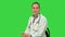 Doctor have a positive conversation with a patient, sitting on a Green Screen, Chroma Key.