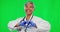 Doctor, heart and hands with woman on green screen for kindness, support and medicine. Healthcare, love and medical with