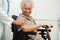 Doctor help Asian elderly woman disability patient sitting on wheelchair in hospital, medical concept