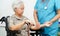 Doctor help Asian elderly woman disability patient sitting on wheelchair in hospital, medical concept