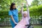 Doctor help and care Asian senior woman patient exercise in the morning on wheelchair at park in hospital