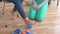 Doctor helps a teenage girl in a wheelchair with orthopedic problems to do exercises to correct flat feet close up