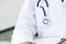 Doctor with his stethoscope in his breast pocket, closeup view or the instrument, on white.
