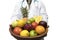 Doctor holding basket assort fresh fruits and vegetables isolated on white background