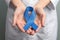 Doctor holding blue awareness ribbon, closeup. Symbol of medical issues