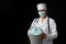 Doctor holding bucket full of used facial masks, throwing them away as symbol of epidemic ending