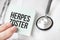 Doctor holding card in hands and pointing the word HERPES ZOSTER