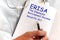 Doctor holding a card with text ERISA, medical concept