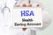 Doctor holding a card with text HSA Health Saving Account medical concept