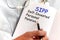 Doctor holding a card with text SIPP Self-Invested Personal Pension medical concept