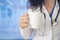 Doctor holding coffee cup with stethoscope and looking up in the morning