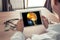 Doctor holding a digital tablet with x-ray of head and pain in the front of brain and neck. Migraine and headache concept