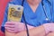 The doctor is holding euros bills in his hand, close-up. Concept of paying doctors during the flu virus and other diseases