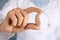 Doctor holding hearing aid, closeup