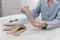 Doctor holding an insole while sitting at a table. Orthopedist tests the medical device. Orthopedic insoles. Foot care