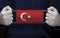 Doctor holding medical face mask with Turkey flag