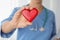 Doctor holding red heart in hand, closeup