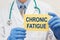 Doctor holding sign with text CHRONIC FATIGUE