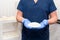 Doctor holding silicone implant for breast augmentation, space for text. Plastic surgeon hands holding silicon breast implants.