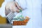 Doctor holding small grocery basket with medicines closeup