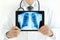 Doctor holding tablet pc with normal male chest x-ray image