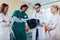 Doctor holding up an x-ray with fellow doctors