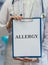 Doctor holds clipboard with allergy diagnosis