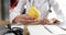 Doctor holds delicious yellow pear in hand