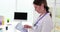 Doctor holds digital tablet with cardiogram in clinic