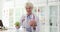 Doctor holds green apple and anatomical model of brain in hands