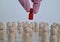 Doctor holds red figurine of man in crowd of people