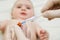 Doctor holds syringe to vaccinate baby