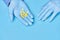 Doctor holds yellow pills in his hands. medical worker in gloves. pharmacology. blue background