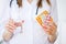 Doctor in hospital office holding pills in hands