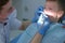 Doctor hygienist making oral hygienic cleaning in dentistry for teen child boy.