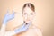 Doctor injecting in a beautiful face of a young woman. Plastic s