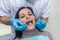 Doctor inspecting patient`s teeth with mirror close up