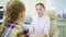 doctor interviews little girl before being examined in ophthalmologist\'s office.