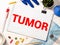 Doctor keeps a card with the name of the diagnosis - tumor. Selective focus. Medical concept