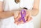 Doctor keeps a purple ribbon as a symbol of epilepsy awareness day close up