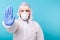 Doctor or lab scientist wearing biohazard protective suit hand gesturing Stop Coronavirus COVID-19 disease global