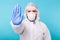 Doctor or lab scientist wearing biohazard protective suit hand gesturing Stop Coronavirus COVID-19 disease global