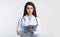 Doctor Lady Reading Medical Report Standing On Gray Studio Background