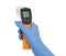 Doctor in latex gloves holding non contact infrared thermometer on background, closeup. Measuring temperature